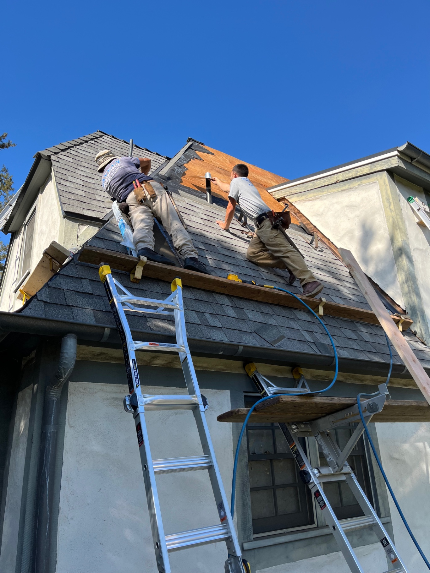 Savely Roofing crew repairing a shingle roof