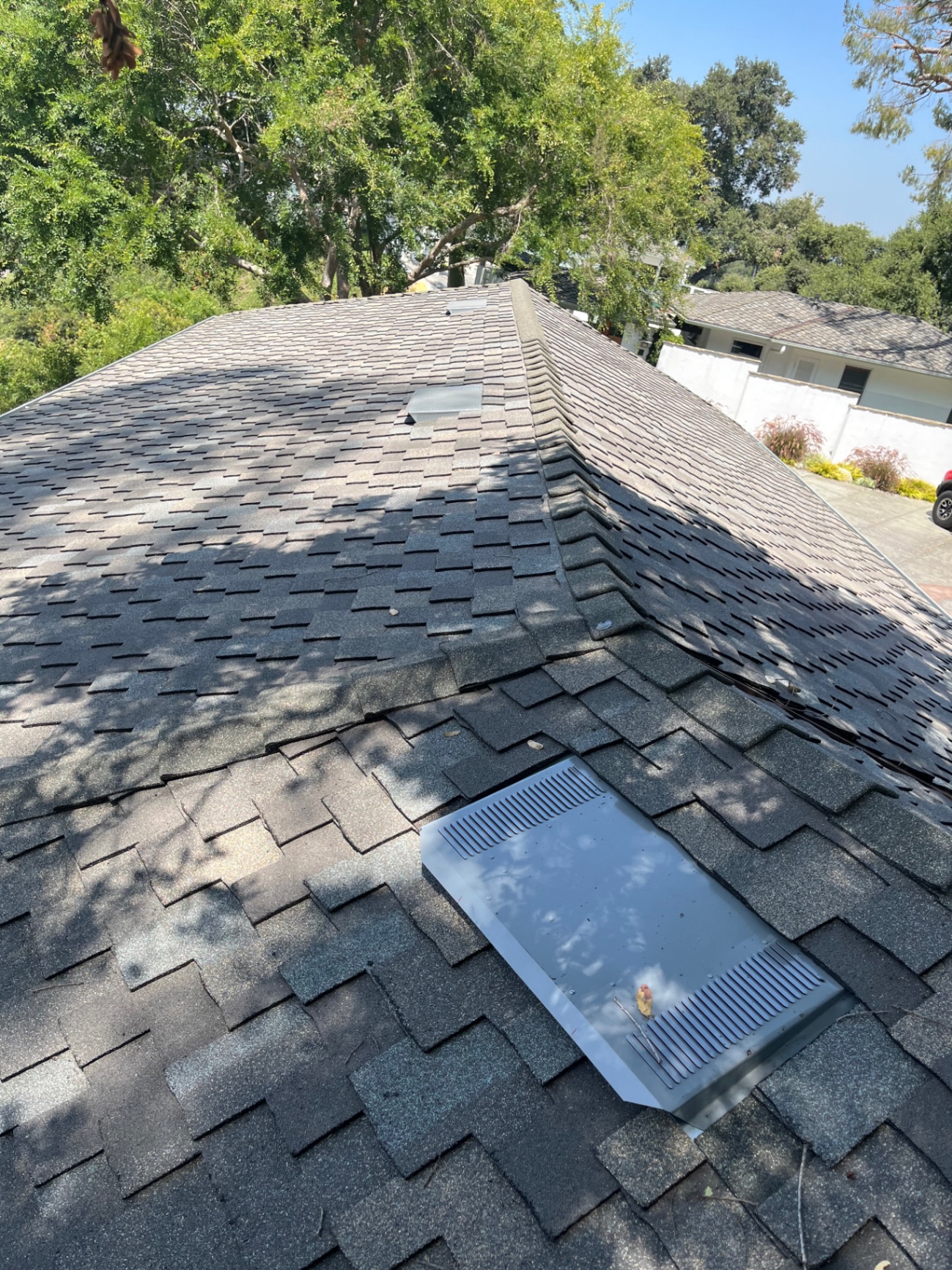 Finished dark shake-style shingle roof installed by Savely Roofing